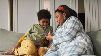 Parent holding phone with child