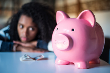 Teen staring at piggybank